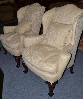 Lot 468 - A pair of wing back chairs with shell knee front feet