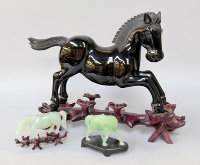 Lot 282 - A Chinese Cherry Amber Effect Model of a Horse...