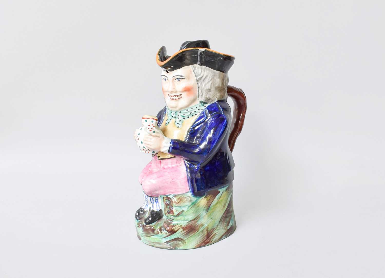 Lot 20 - A Staffordshire Pottery Toby Jug and Cover,...