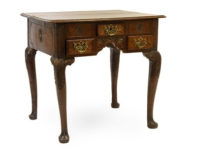 Lot 1329 - A George III Oak Lowboy, the moulded top above...