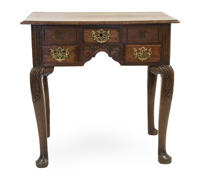Lot 1329 - A George III Oak Lowboy, the moulded top above...