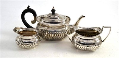 Lot 42 - A matched three piece silver tea set, Birmingham, different date codes, maker's mark T.H