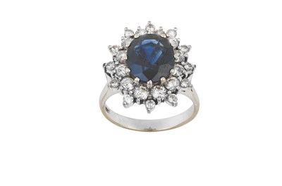 Lot 2063 - A Sapphire and Diamond Cluster Ring the oval...