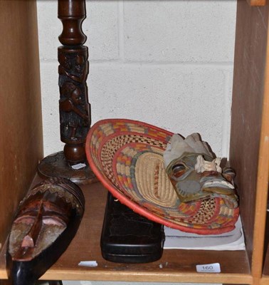 Lot 160 - African board game, African mask, coiled raffia basket, Amazonian mask and an African candlestick