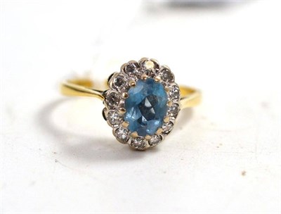 Lot 194 - An 18ct white and yellow gold aquamarine and diamond cluster ring