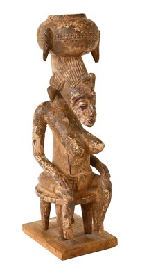 Lot 394 - A Senufo Carved Wood Figure of a Woman, Ivory...