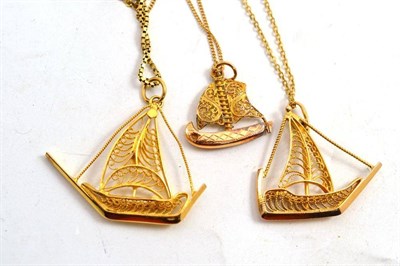 Lot 219 - Three yellow metal filigree boat pendants on chains