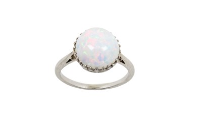 Lot 2386 - An Opal Solitaire Ring the round cabochon opal...