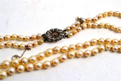 Lot 230 - A double row cultured pearl necklace (with four loose pearls)