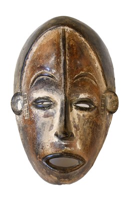 Lot 402 - An Igbo Carved Wood Face Mask, Nigeria, the...