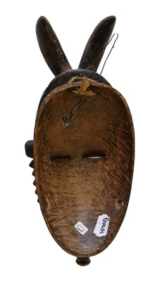 Lot 402 - An Igbo Carved Wood Face Mask, Nigeria, the...