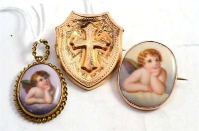 Lot 235 - A cross motif brooch and two Cupid decorated pieces