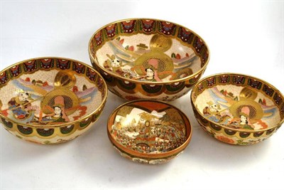 Lot 267 - A Japanese Satsuma bowl decorated with warriors and three graduating Japanese Satsuma bowls