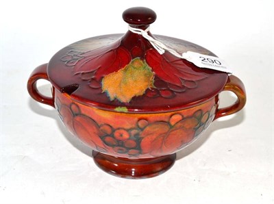 Lot 290 - A William Moorcroft flambé leaf and berry footed twin-handled bowl and cover, with aperture...