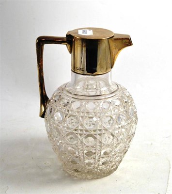 Lot 299 - A silver mounted cut glass claret jug