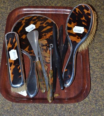 Lot 309 - A four piece silver and tortoiseshell dressing table set; two glove stretchers; button hook and...