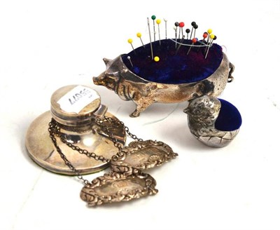 Lot 370 - Silver inkwell, two silver wine labels, a plated pig pin cushion and plated chick pin cushion