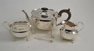 Lot 379 - Silver three piece tea set and sugar tongs