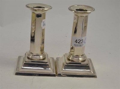 Lot 423 - A pair of Corinthian column candlesticks