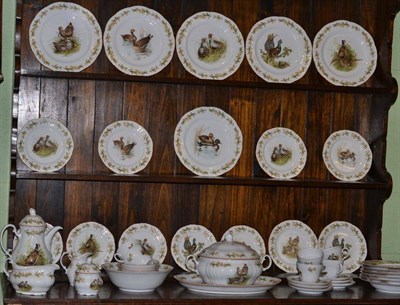 Lot 429 - A large dinner service, decorated with game birds