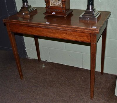 Lot 500 - A late George III mahogany fold over tea table