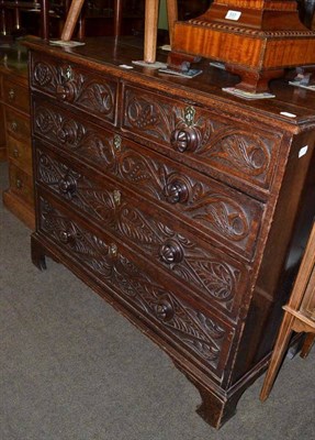 Lot 532 - A carved oak chest of drawers