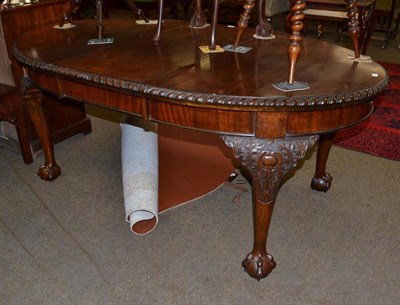 Lot 547 - A Victorian mahogany wind-out oval dining table with carved legs and claw and ball feet