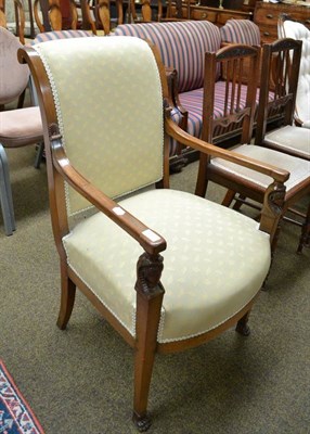 Lot 577 - A carved mahogany elbow chair, the front supports carved with Egyptian heads and paw feet