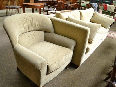 Lot 591 - Cream upholstered two seater sofa and a modern armchair