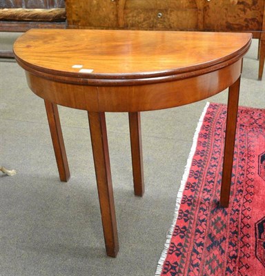 Lot 596 - A 19th century mahogany demi-lune fold-over tea table and a reproduction bedside chest