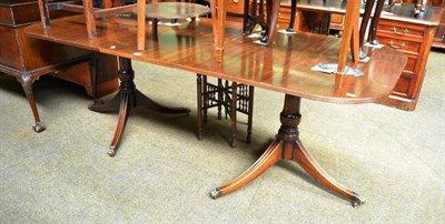 Lot 607 - A reproduction mahogany twin pedestal dining table