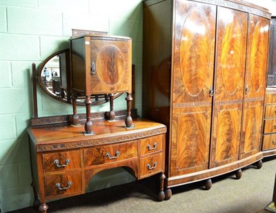 Lot 627 - An early 20th century mahogany four piece bedroom suite comprising: double door wardrobe, chest...