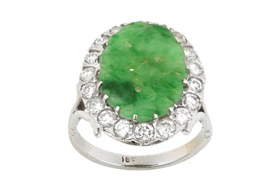 Lot 2120 - A Jade and Diamond Cluster Ring the oval...