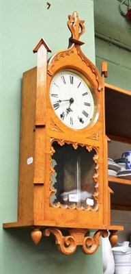 Lot 647 - An oak cased striking wall clock