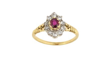Lot 2436 - A Ruby and Diamond Cluster Ring the oval cut...