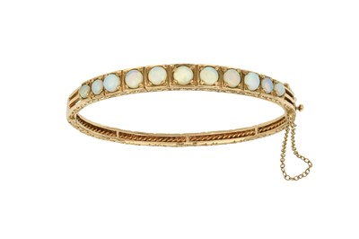 Lot 2472 - A 9 Carat Gold Opal Bangle eleven round cut...