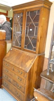 Lot 739 - A reproduction yew bureau bookcase, an onxy circular coffee table and a standard lamp