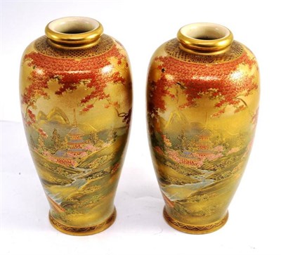 Lot 43 - A pair of Japanese satsuma vases, profusely decorated in gilt with a temple in a mountainous...