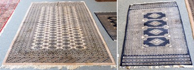 Lot 1261 - "Bukhara" Rug, the camel field with four...