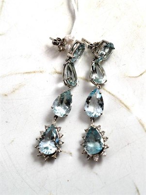 Lot 66 - A pair of aquamarine and diamond drop earrings, the four pear cut aquamarines chain linked to...