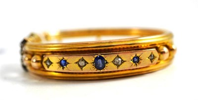 Lot 75 - A sapphire and diamond tramline bangle