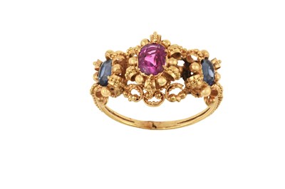 Lot 2420 - A Ruby and Sapphire Three Stone Ring an oval...