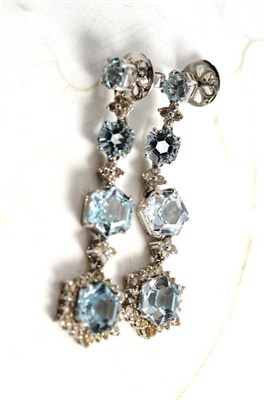 Lot 80 - A pair of blue topaz and diamond drop earrings, the graduated hexagonal shaped blue topaz spaced by