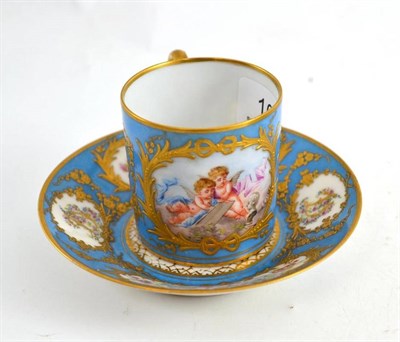 Lot 109 - A Sevres cup and saucer, painted with cherubs, on a blue and gilt ground