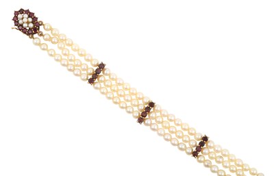 Lot 2448 - A Triple Row Cultured Pearl and Garnet...