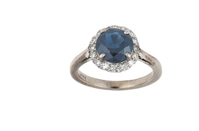 Lot 2335 - A Sapphire and Diamond Cluster Ring the round...