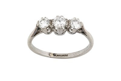 Lot 2396 - A Diamond Three Stone Ring the graduated round...