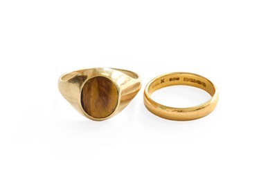 Lot 230 - A 22 Carat Gold Band Ring, finger size N; and...