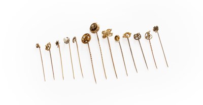 Lot 250 - Thirteen Stick Pins, of varying design,...