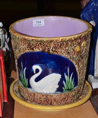 Lot 154 - Victorian majolica planter and stand, moulded with swans in bullrushes